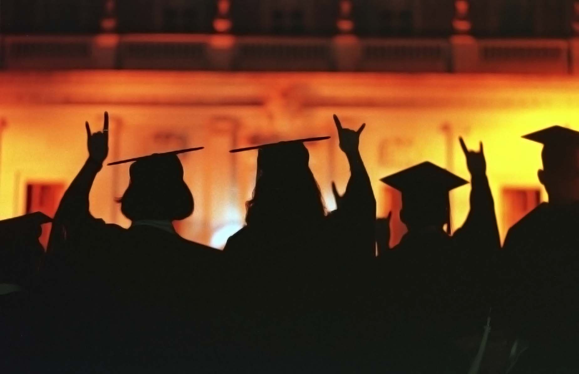 the silhouettes of students at commencement