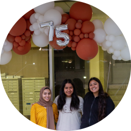 iSchool students in front of a balloon display